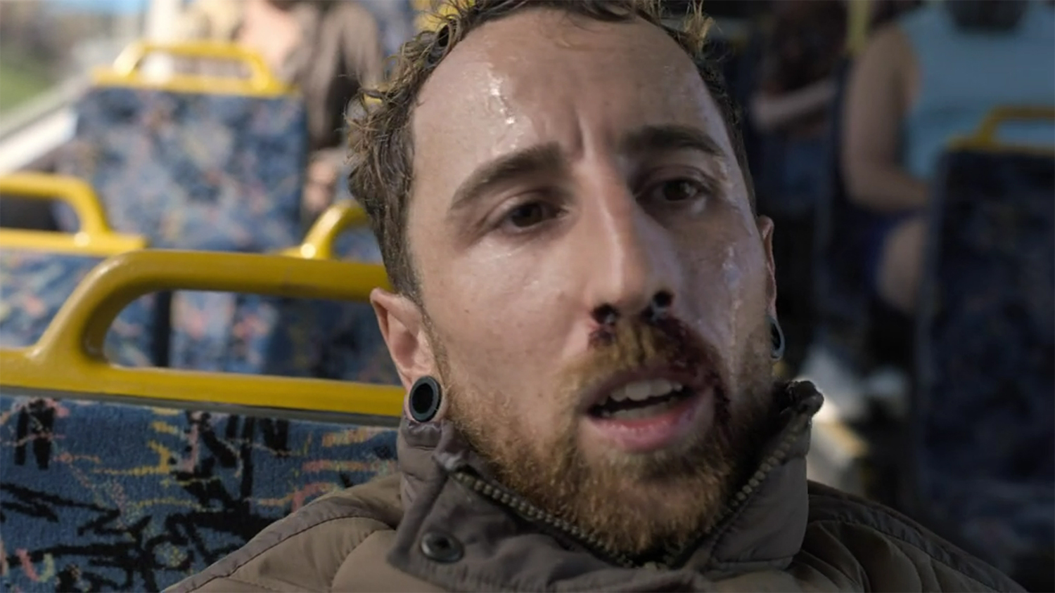 A dude feeling the heat on the bus.