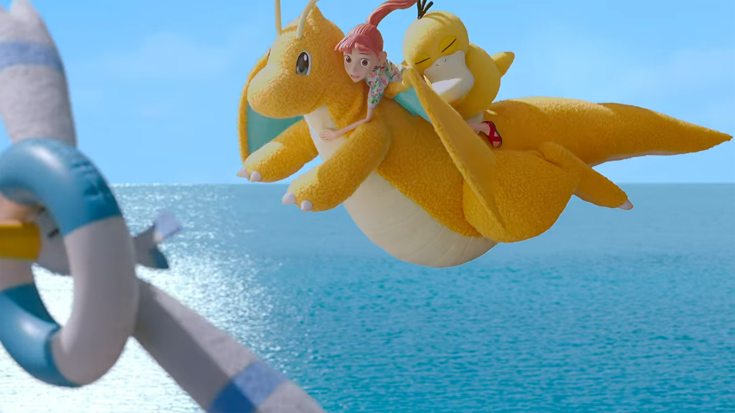 Haru and Psyduck on the back of a Dragonite chasing a Wingull.
