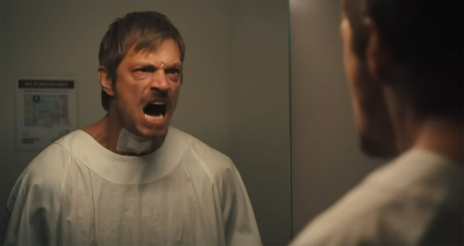 Brian screams at a mirror.