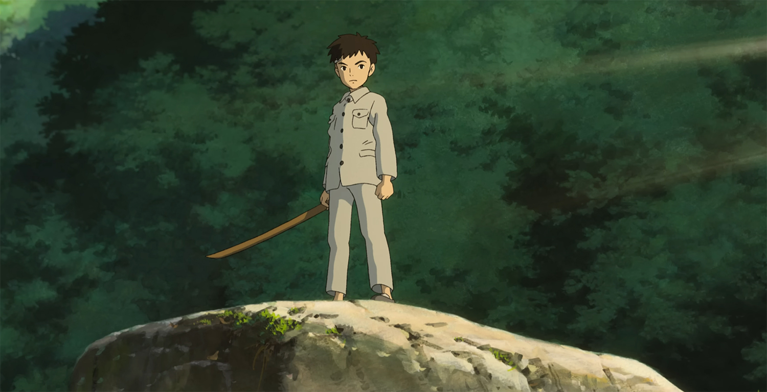 Mahito stands on a rock.