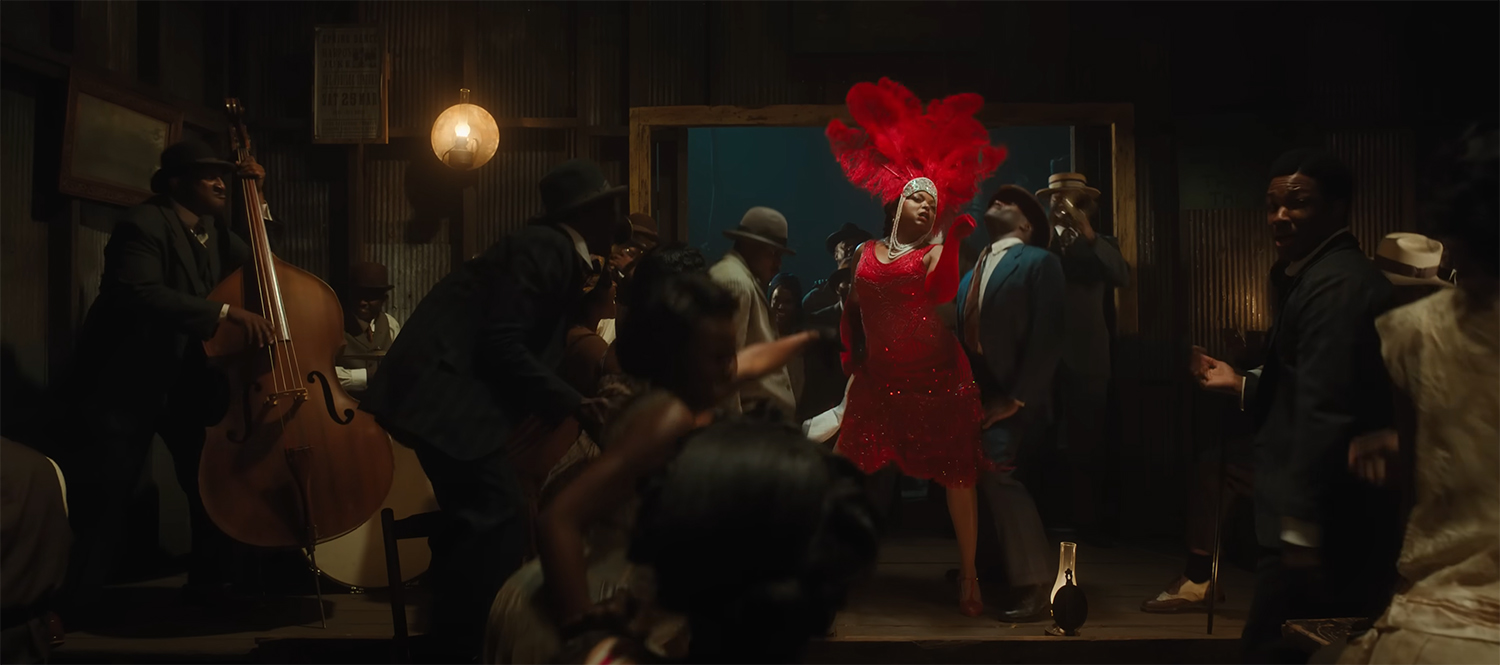 Taraji P. Henson in a red dress performing to the crowd.