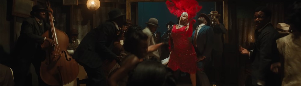 Taraji P. Henson in a red dress performing to the crowd.
