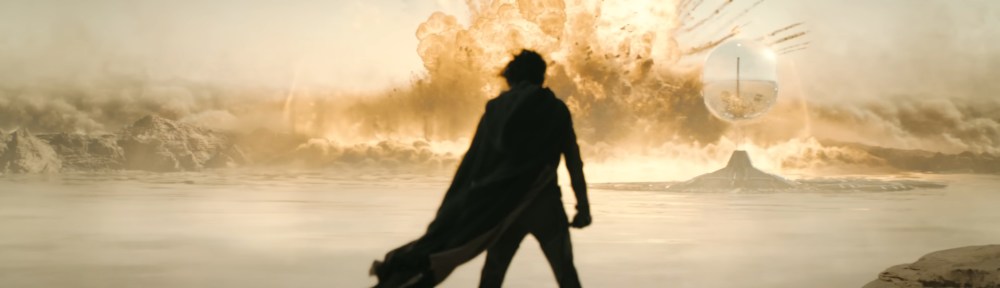 Paul stands in front of an explosion.