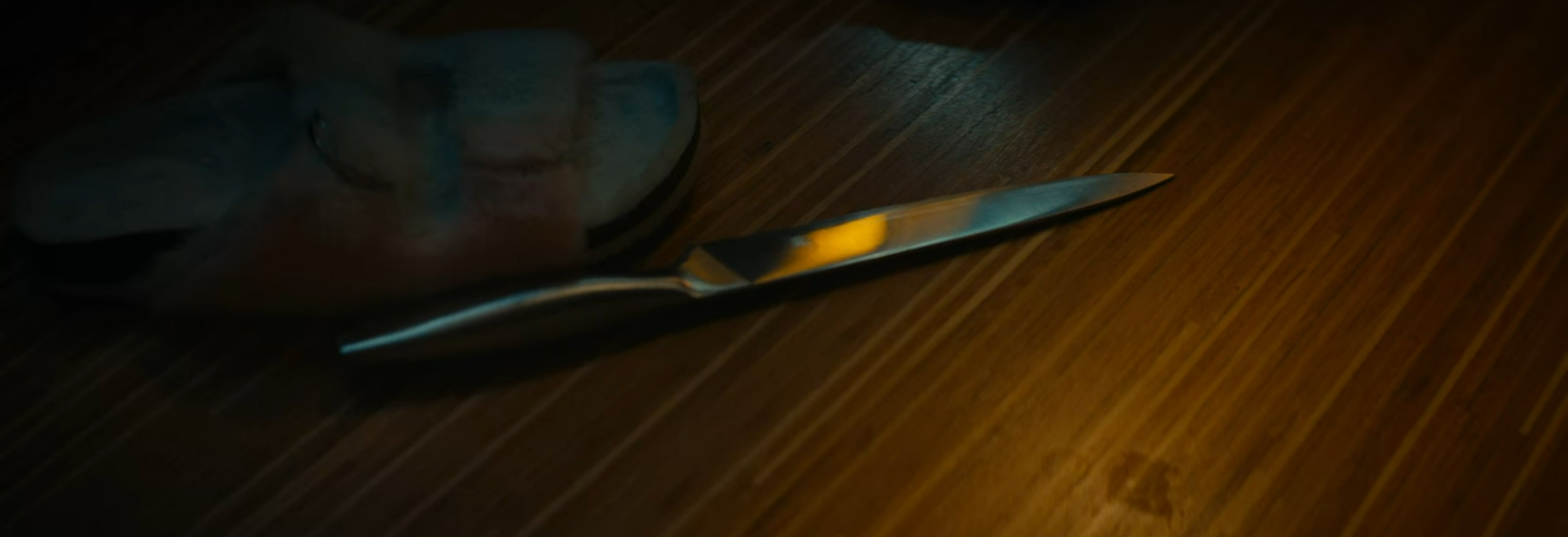 A knife falls to the floor.