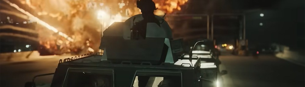 An explosion behind an army truck.