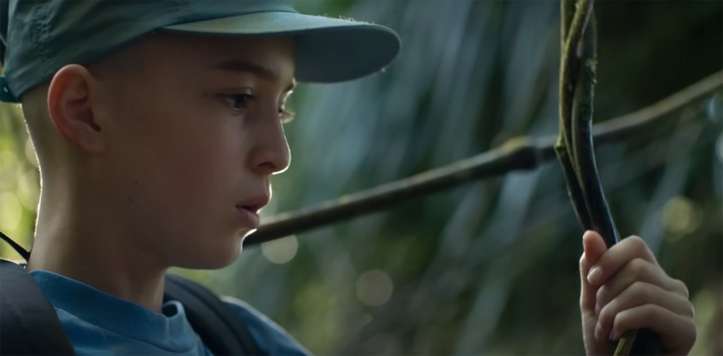 Sam holds onto a vine for support.