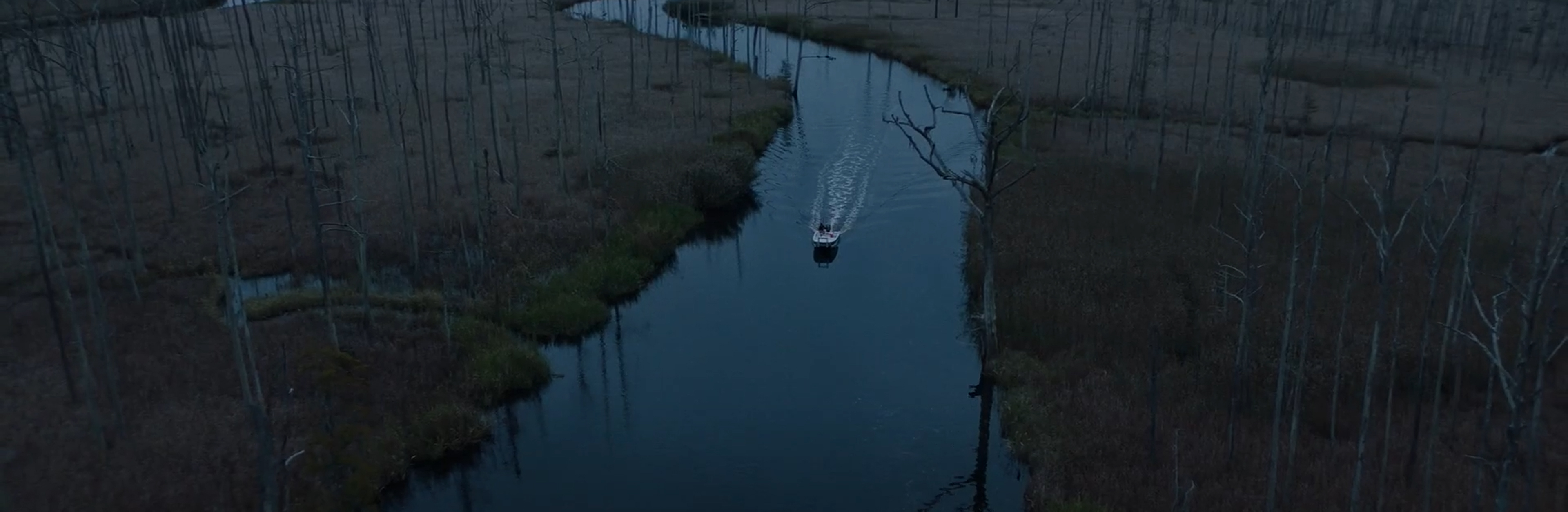A boat slinks through the sound.