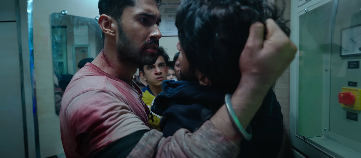 Amrit holds a bandit by his hair.