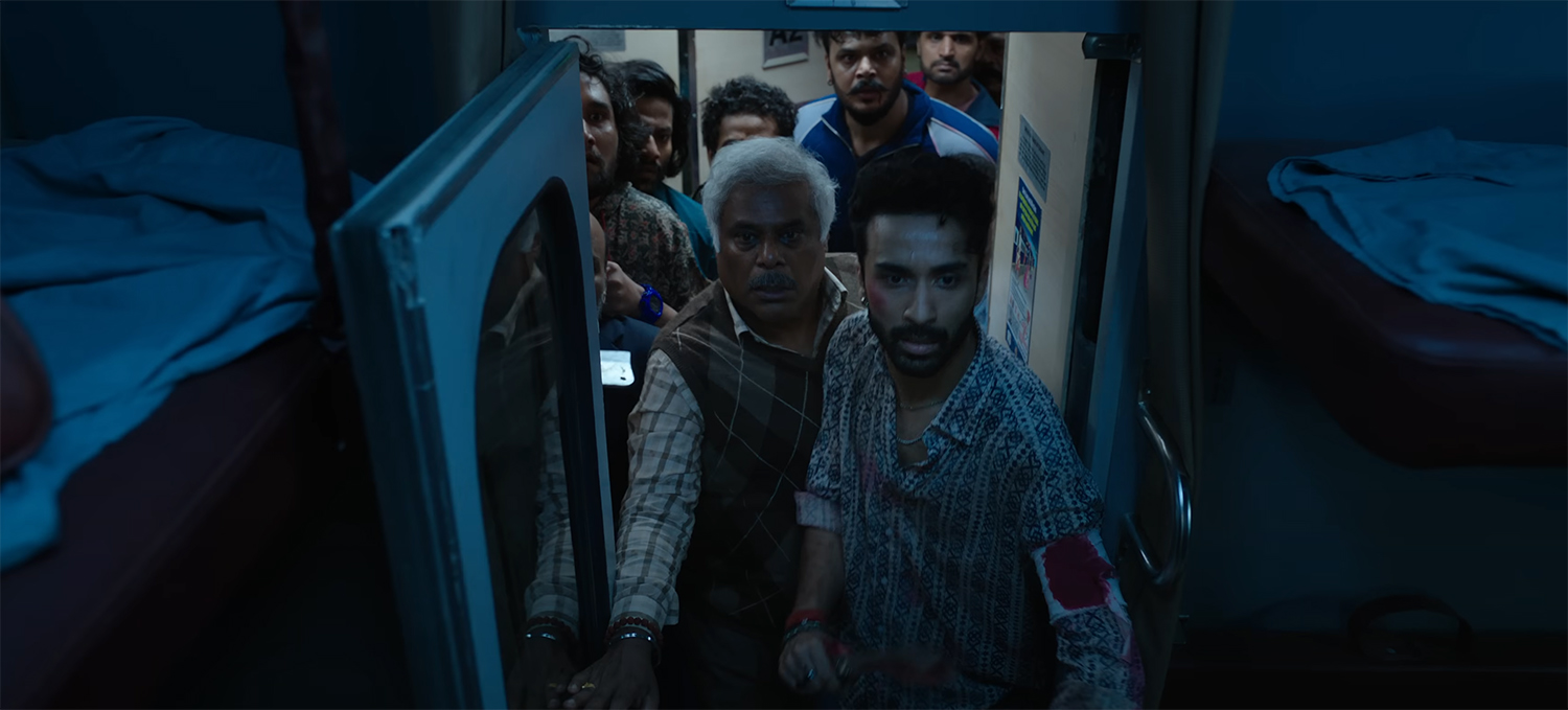 The bandits enter a train cabin that has had all its lights turned off.