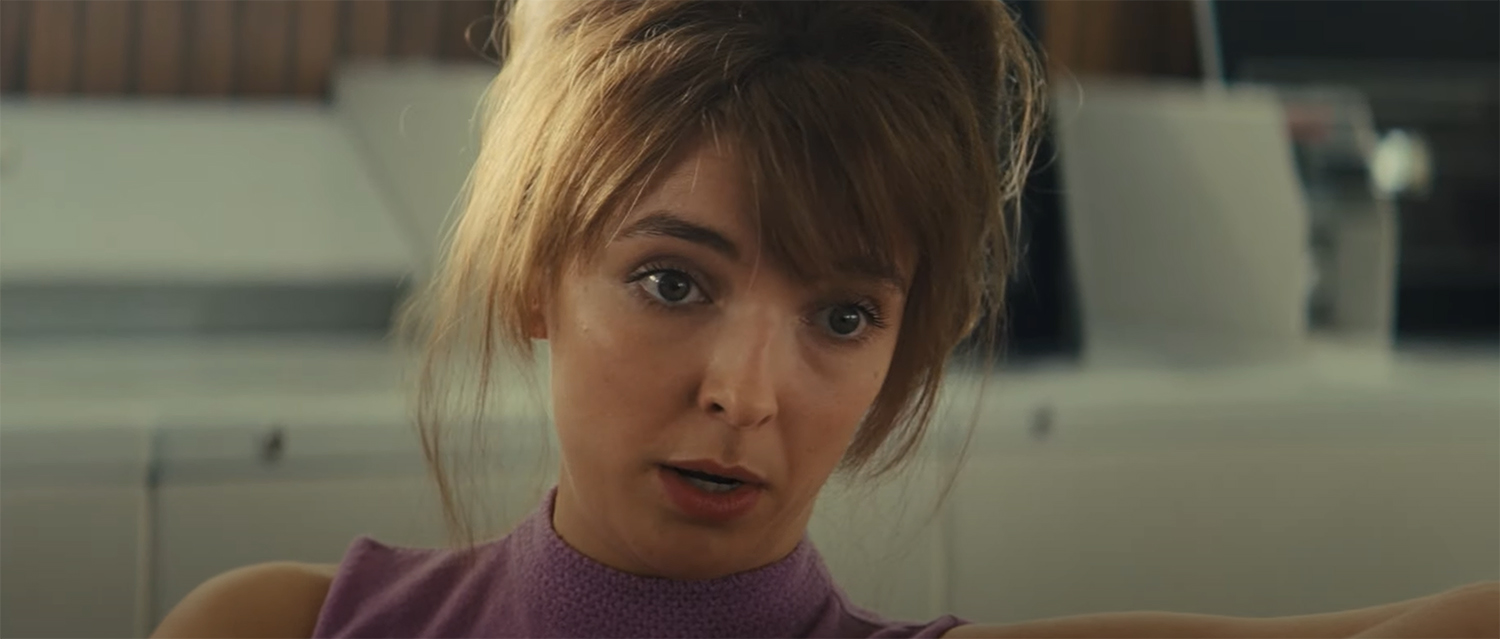 Jodie Comer in big hair and a purple top owning the scene.