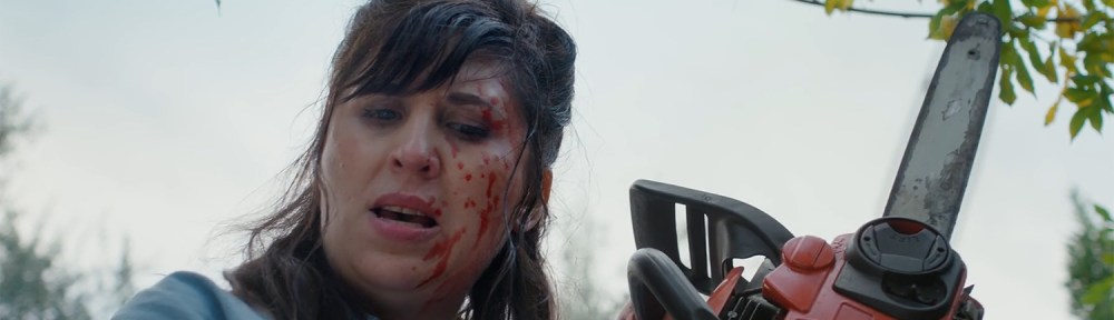 Abi holds a chainsaw.