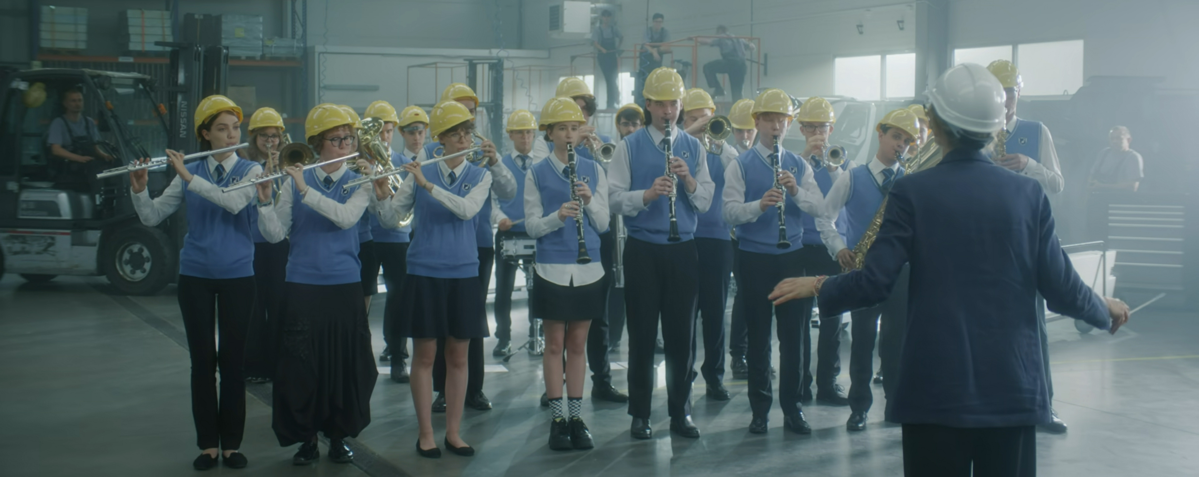 the school band plays in hard hats.