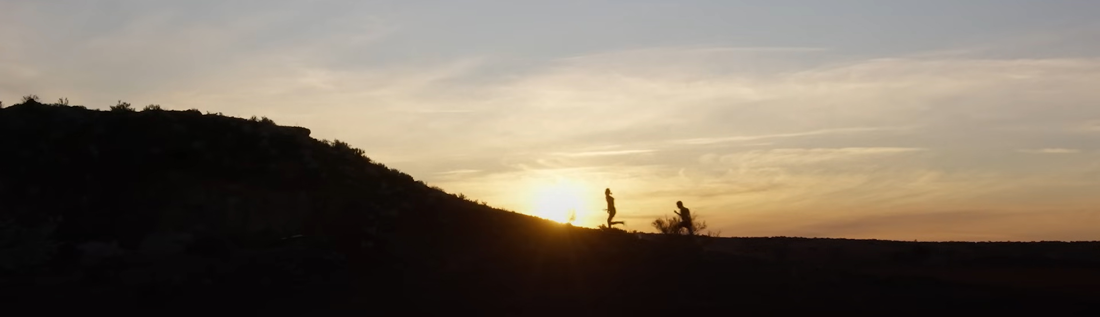Kid Snow and Lizard run up a hill.