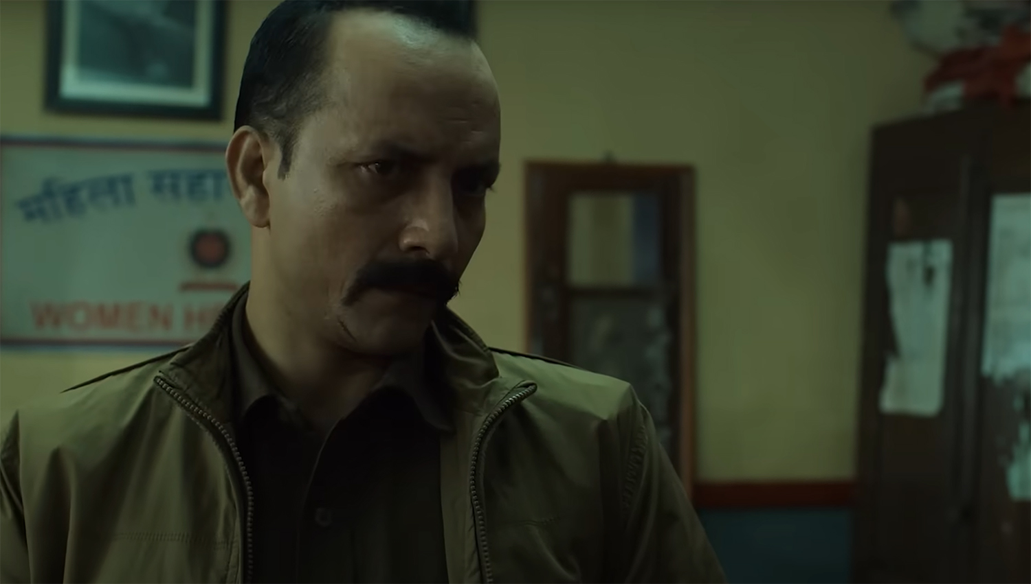 Sub Inspector Ram Charan Pandey takes a bribe.