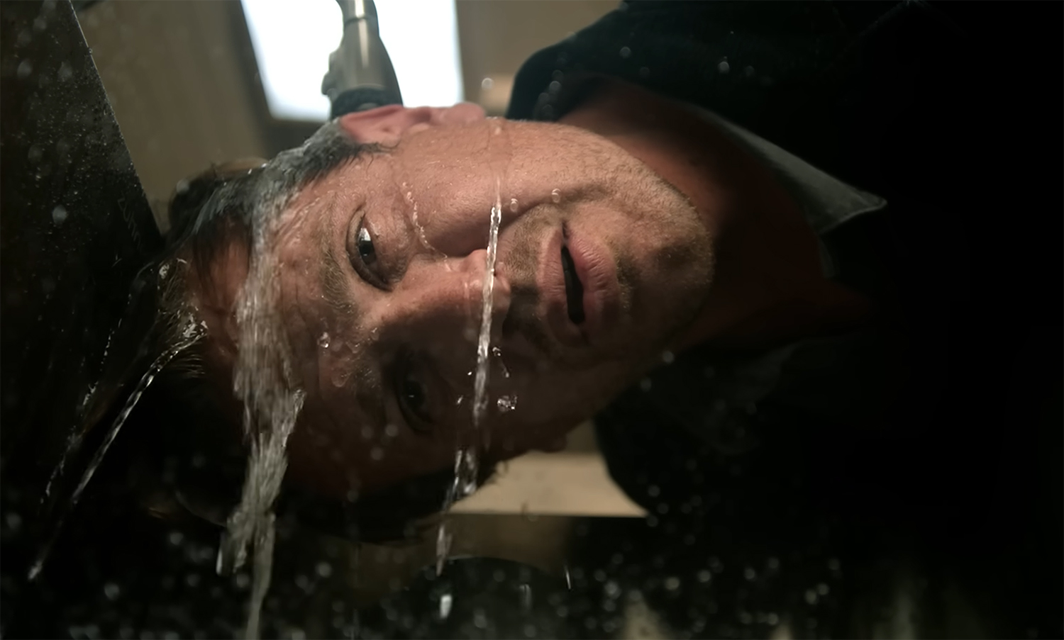 Jimmy runs his head under water.