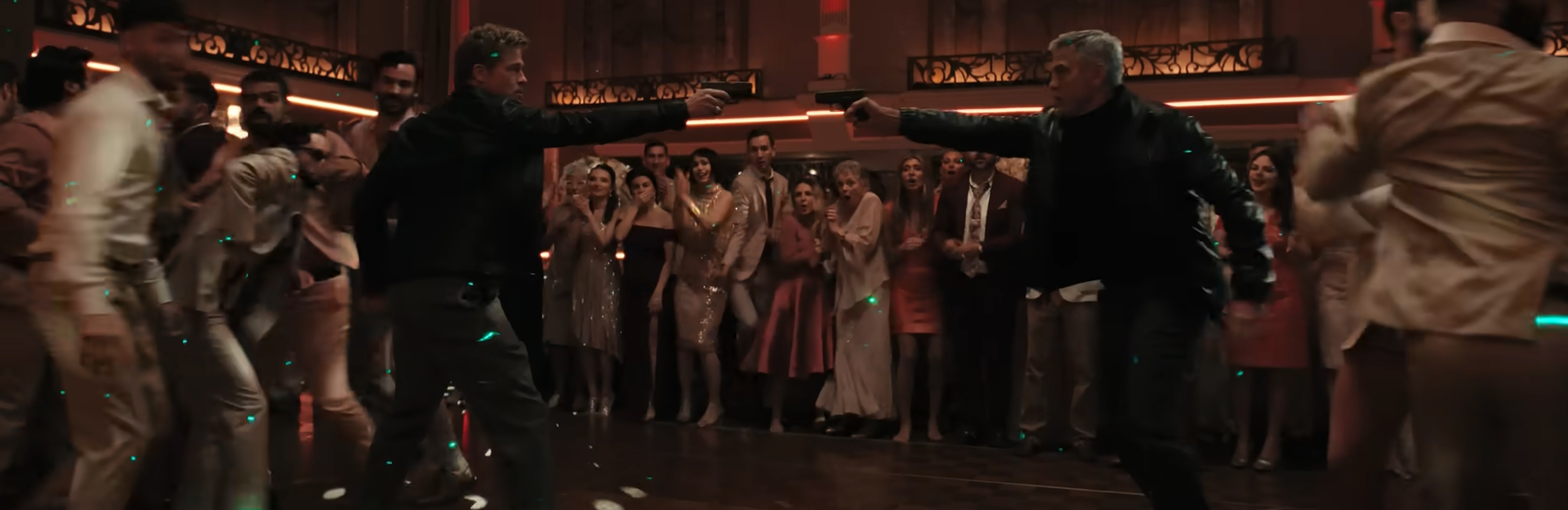 Brad Pitt and Georgy Clooney draw guns on each other.