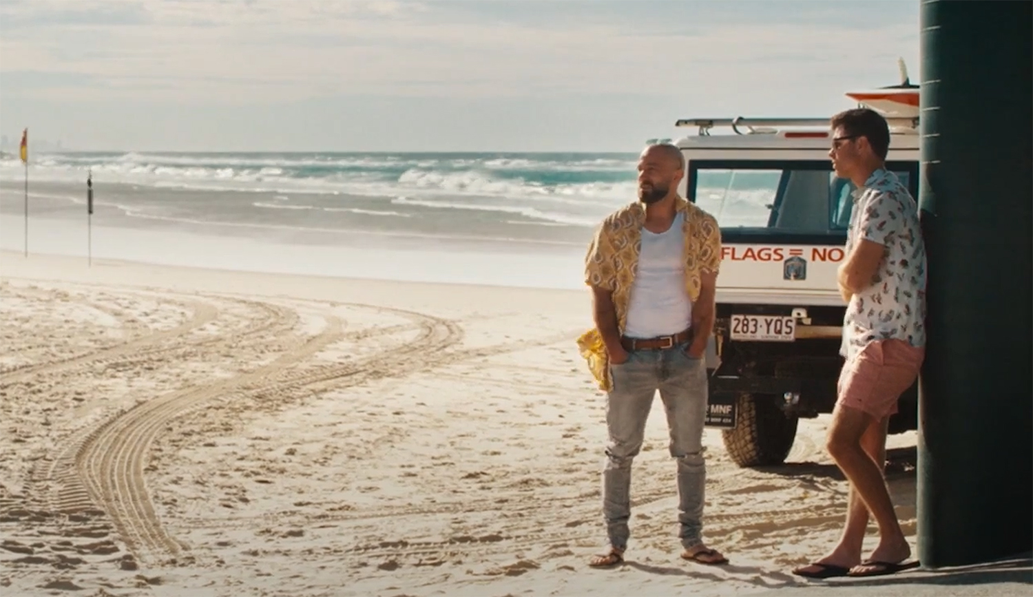 The cousins standing on a beach.