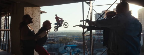 Doing a motorbike stunt.