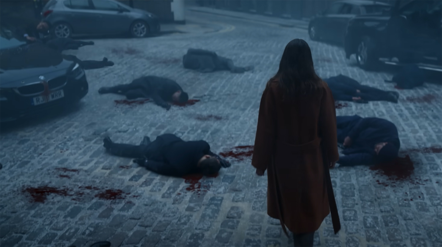 Helen walks through a road full of corpses.