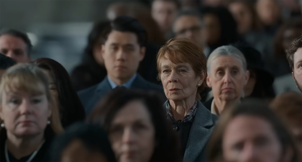 Margaret Roylin stares out from the crowd of faces.