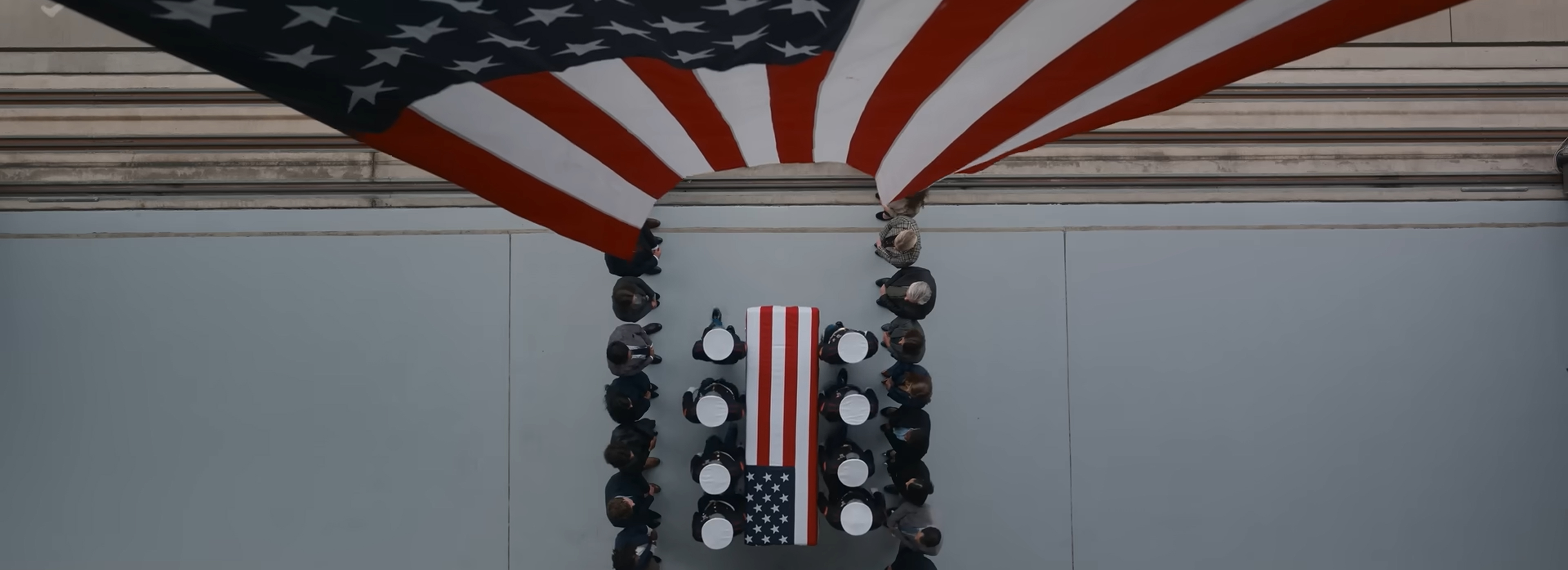A coffin draped in the USA flag.