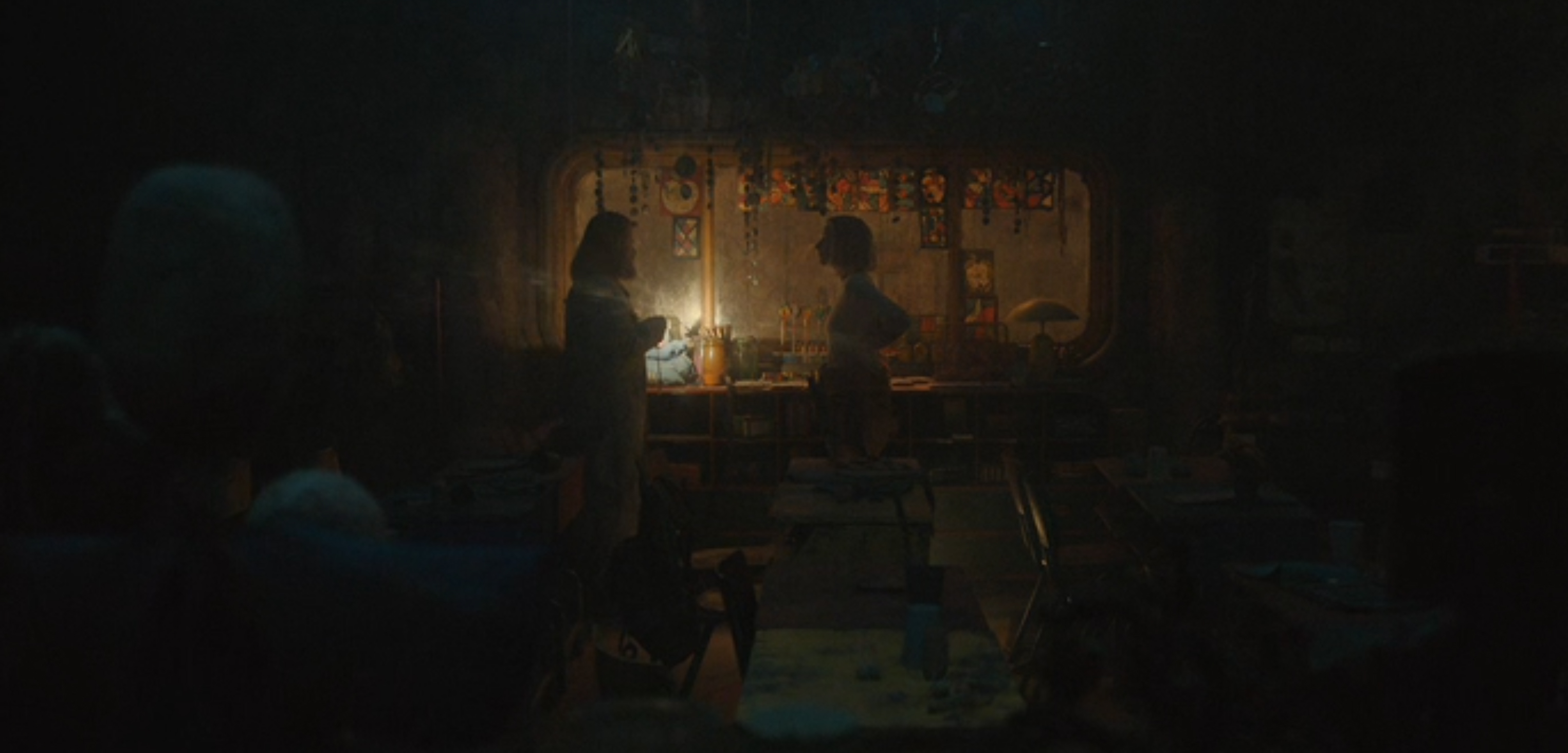 Soli and Juliette talk in an old classroom.