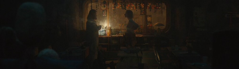 Soli and Juliette talk in an old classroom.