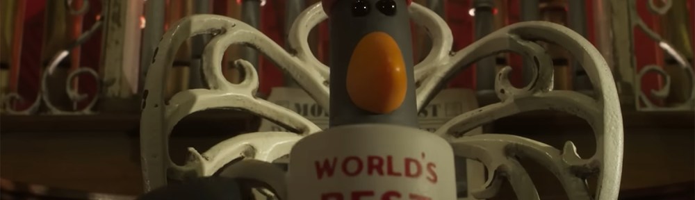Feathers McGraw drinking out of a World's Best Boss mug.