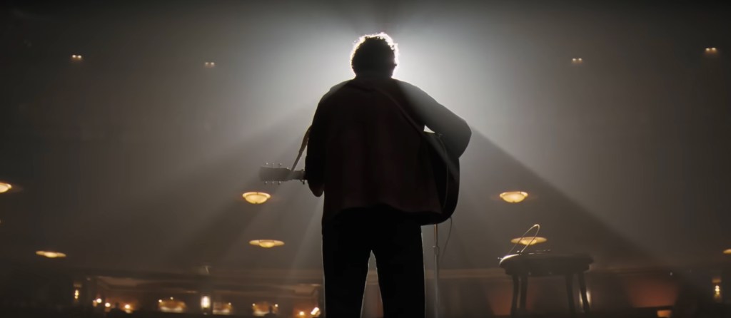 Bob black lit while playing the guitar. 