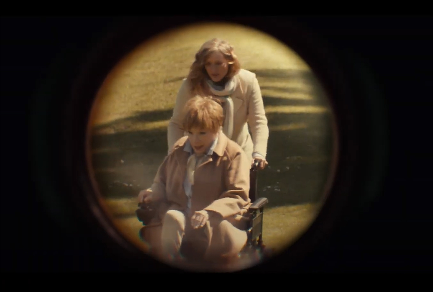 Phil spys on his downstairs neighbour through a telescope.