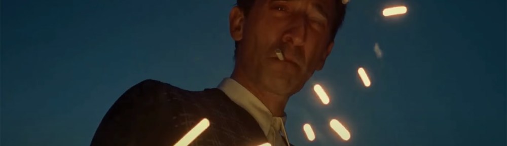 Adrien Brody watches sparks fly through the air.