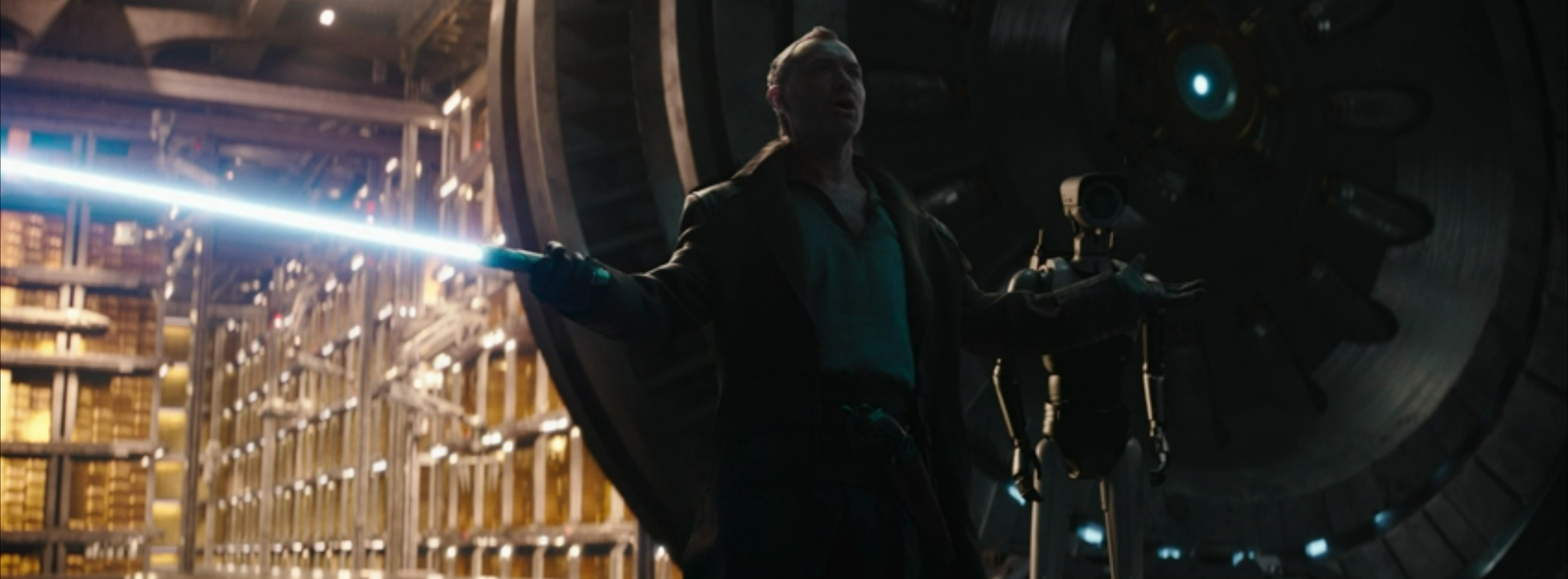 Jod performs for the droids with a lightsabre menacing those who know.