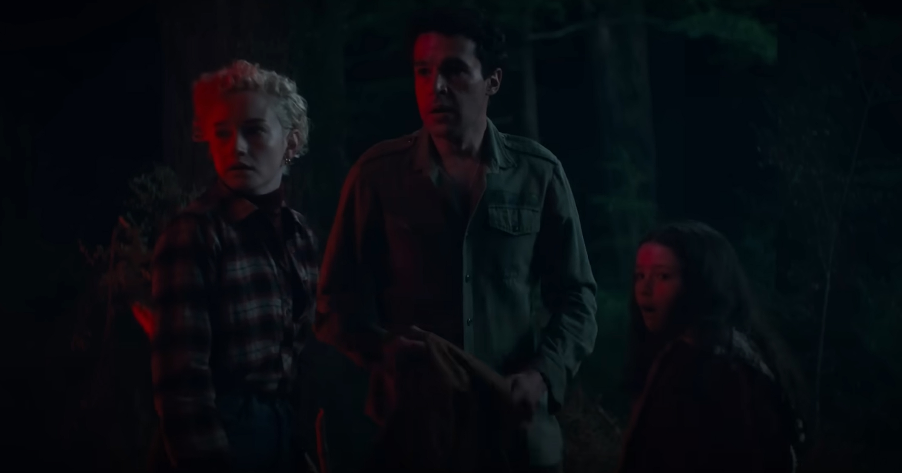 A family stands illuminated by a red light.