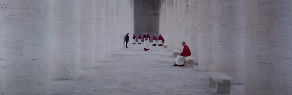 Red Cardinals against white marble columns. 