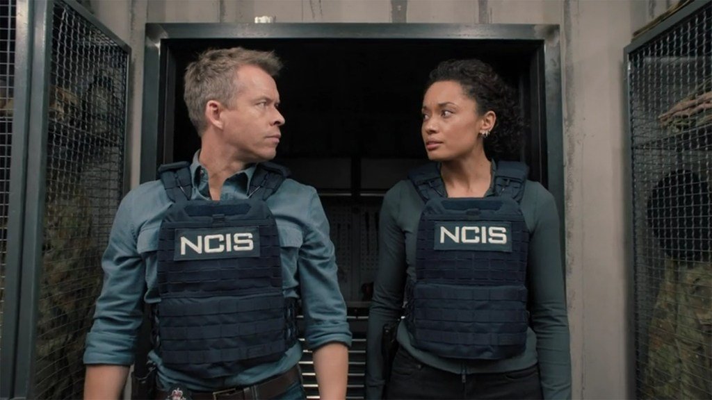 Mack and JD look at each other with concern. 