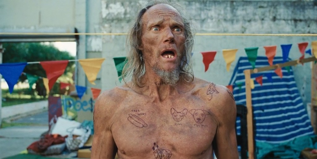 A homeless man covered in tattoos. 