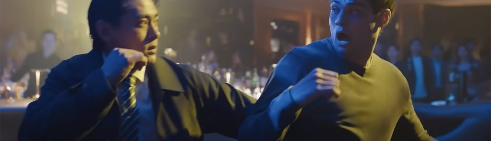 Owen and Jang help each other in a fight.