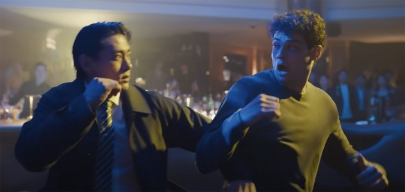 Owen and Jang help each other in a fight.