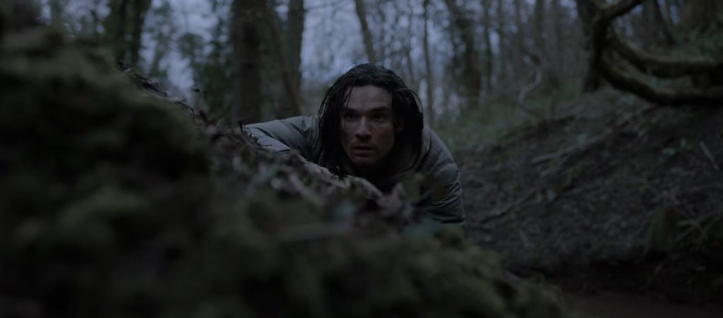 Jake spies over a ridge. 