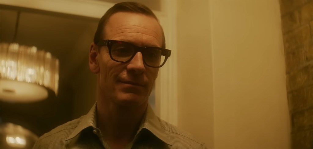 Michael Fassbender in the worm glow of a chandelier. 