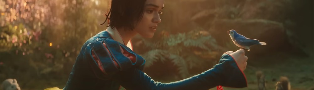 Snow White holds a bird on her finger.