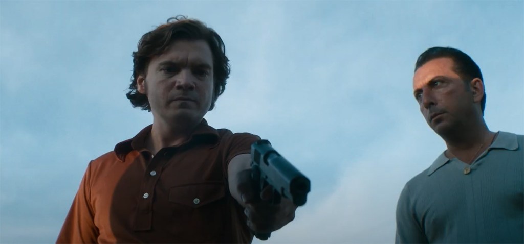 Emile Hirsch holds a gun. 