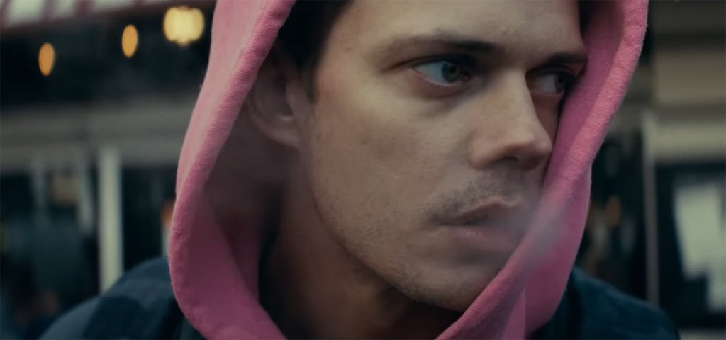 Bill Skarsgård in a pink hoody.