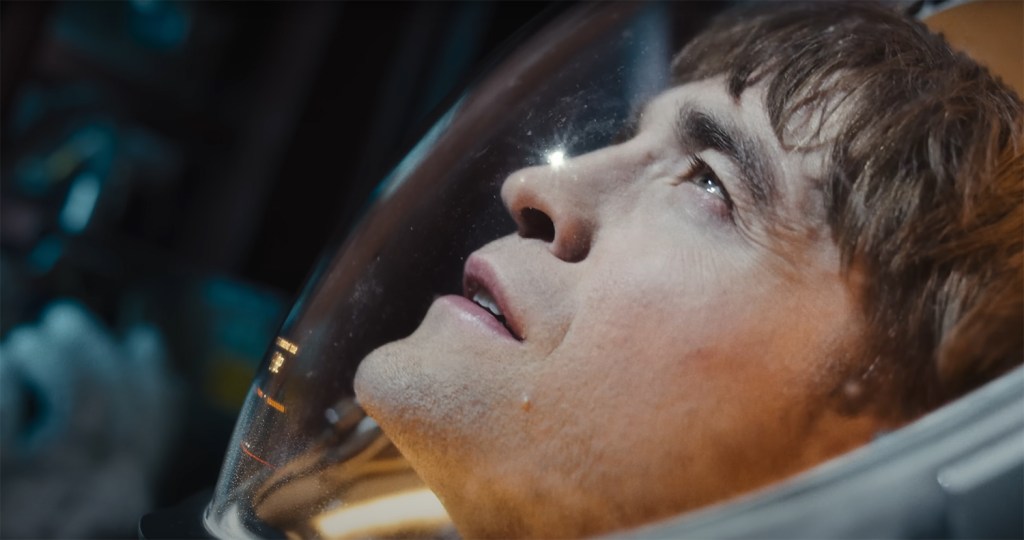 Mickey looks up in a spacesuit. 