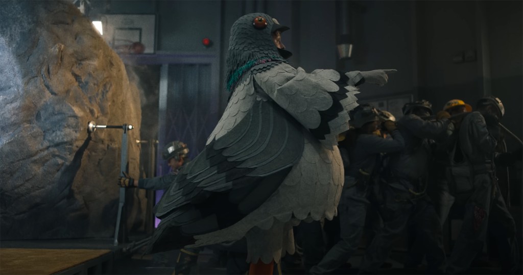 A man in a pigeon costume. 