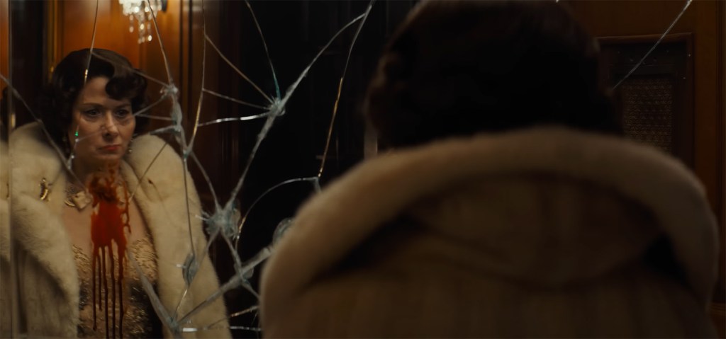 Debra Messing looks at a smashed mirror. 