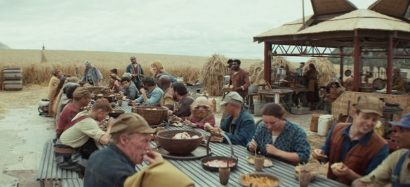 Everyone in the village sitting down to eat lunch.