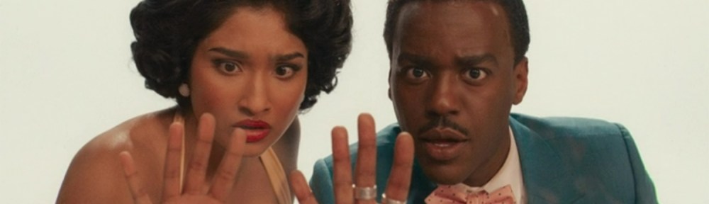 The Doctor and Belinda peer behind the screen.