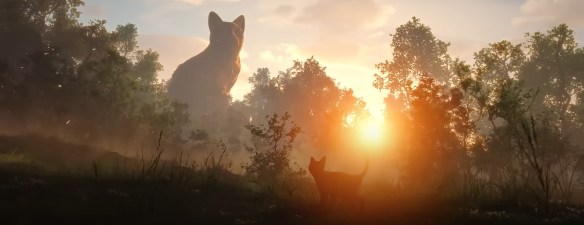 Cat looks up to a big sculpture of a cat.
