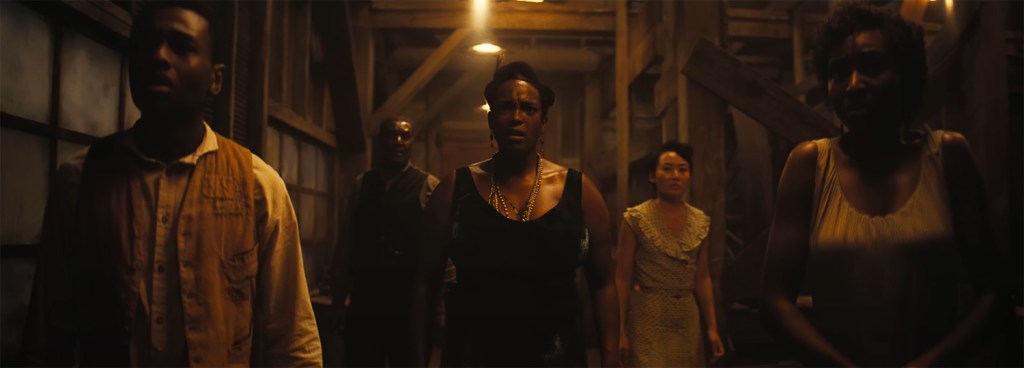 The group looks horrified at the sound of someone who was once dead but is now talking. 